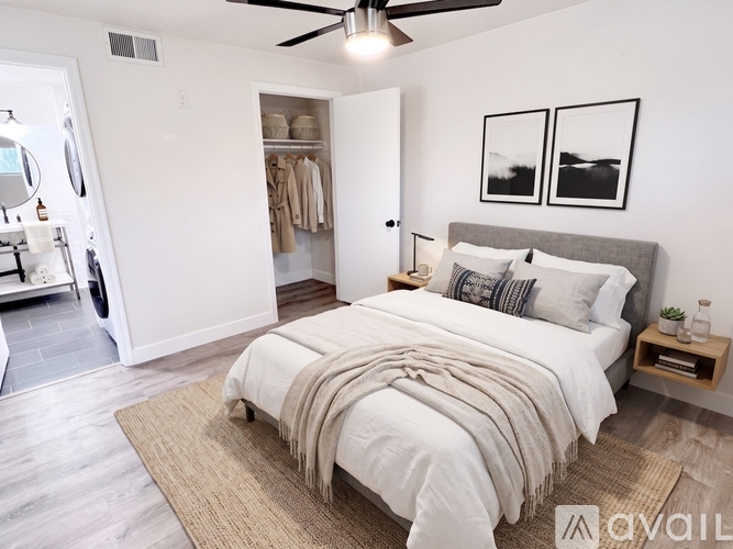 A bedroom with a large bed and a ceiling fan.