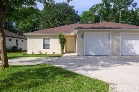 A two-story house with a garage is for sale.