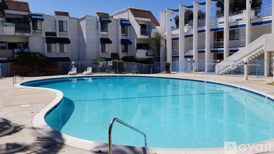 A swimming pool in front of apartment buildings.