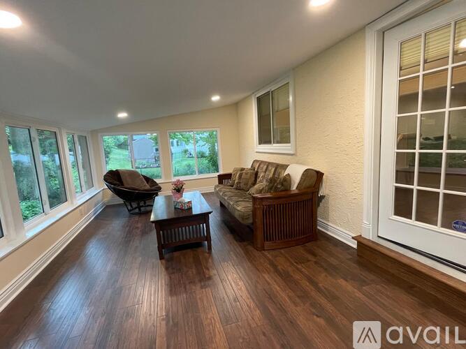 A living room with a brown sofa and a wooden coffee table.