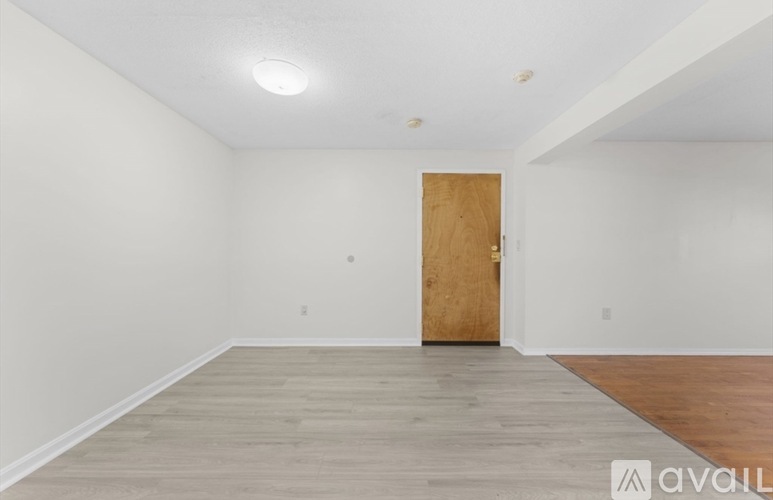 A room with a wooden door and a wooden floor.