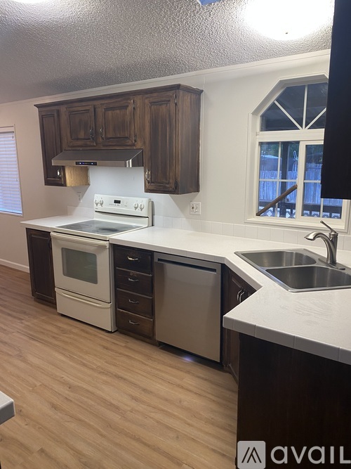 A kitchen with wooden cabinets and stainless steel appliances.