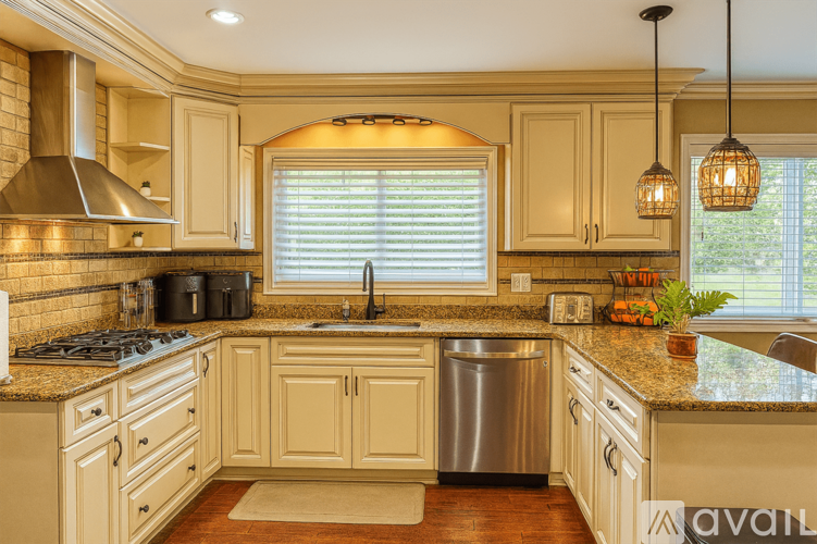 A kitchen with wooden cabinets and a granite countertop.