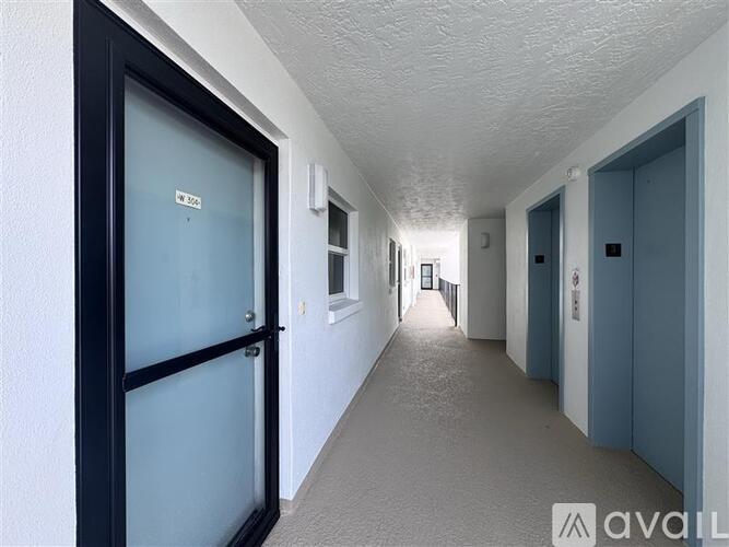 A long hallway with doors on both sides.
