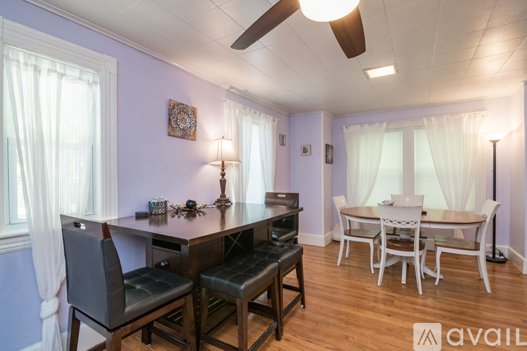 A dining room with a table set for four.