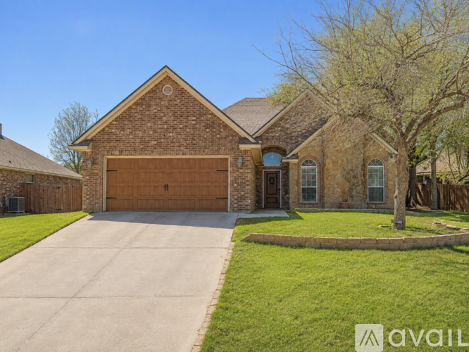 A house with a brick facade and a large driveway.