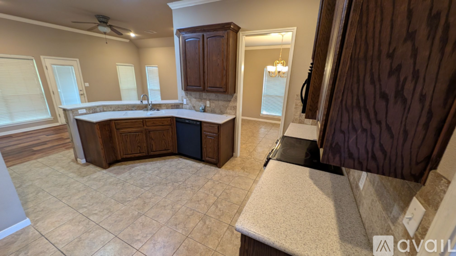 A kitchen with a large island and wooden cabinets.