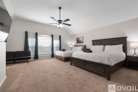 A bedroom with a large bed and a couch.