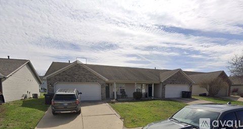 A house with a car parked in front of it.
