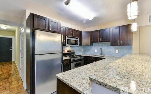 A kitchen with granite countertops and stainless steel appliances.