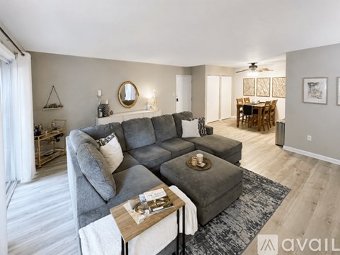 A living room with a grey sofa and a wooden coffee table.