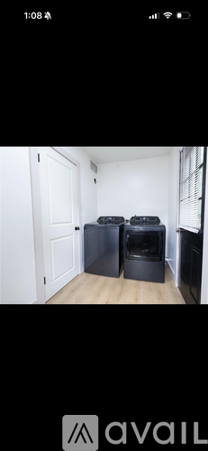 A room with a white door and a black object on the floor.
