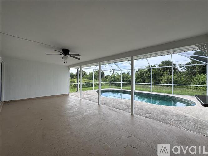 A room with a ceiling fan and a pool table.