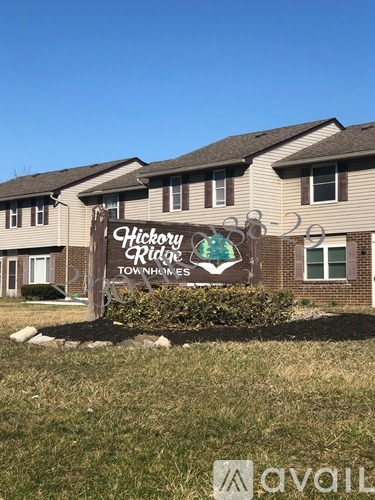 A sign for Hickory Ridge Townhomes is displayed in front of a building.