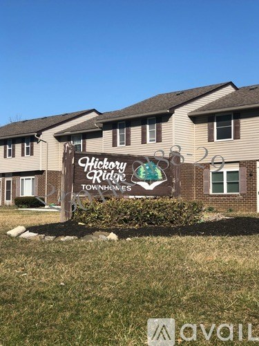 A sign for Hickory Ridge Townhomes is displayed in front of a building.