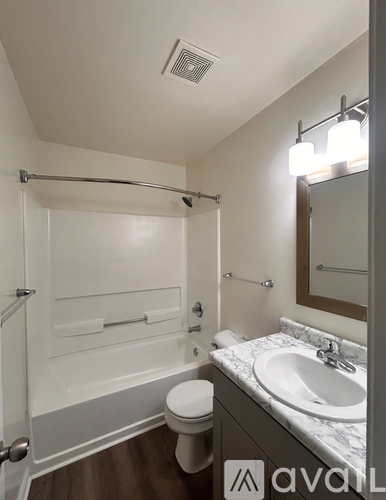 A bathroom with a toilet, sink, and shower.