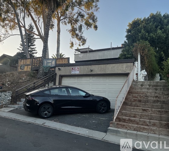 A black car is parked on the side of a street.