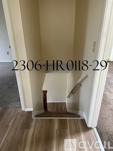 A hallway with a staircase leading to the second floor.