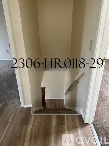 A hallway with a staircase leading to the second floor.