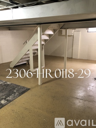 A staircase in a building with the number 2306-1H-R-0118-29 displayed on the wall.