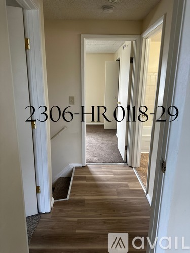 A hallway with a door on the left and a door on the right.