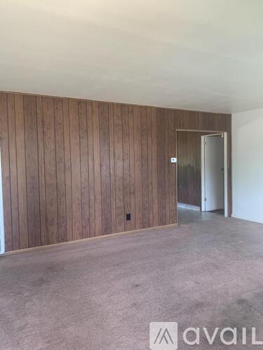 A room with wooden paneling and a carpeted floor.
