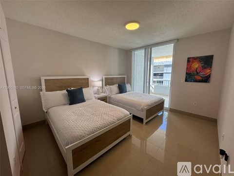 A bedroom with two beds and a painting on the wall.
