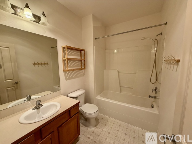 A white bathroom with a sink, toilet, and bathtub.