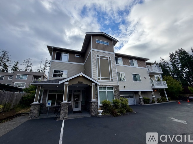 A modern two-story house with a large front porch and a garage.