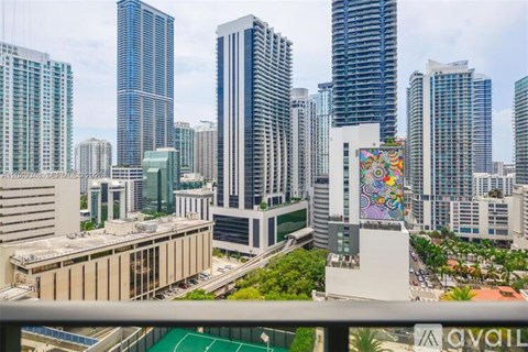 A cityscape with a variety of buildings, including a tall skyscraper with a colorful mural on the side.