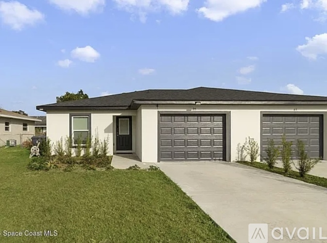 A two-story house with a garage is for sale in Space Coast MLS.