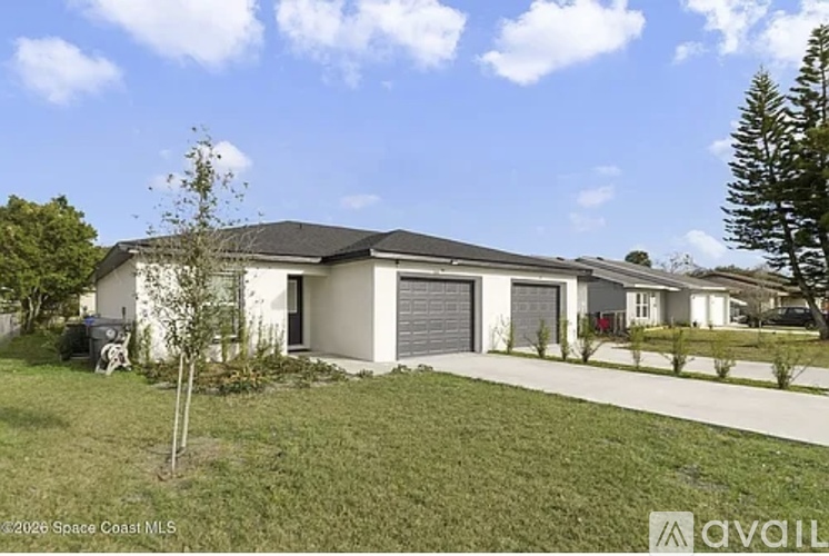 A house with a white garage door is for sale.