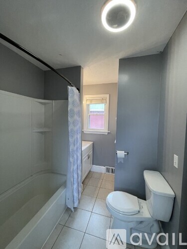 A bathroom with a toilet, sink, and shower.