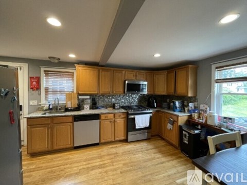 A kitchen with wooden cabinets and a black countertop.