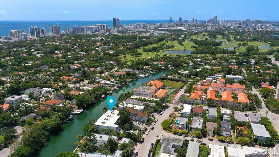 A bird's eye view of a residential area with a river running through it.