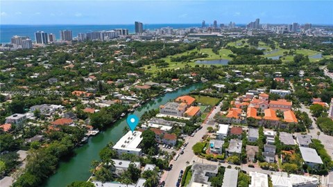 A bird's eye view of a residential area with a river running through it.