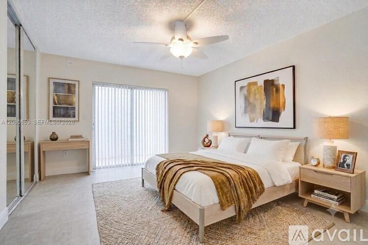 A bedroom with a bed, nightstand, and a painting on the wall.