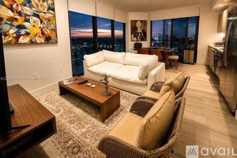 A living room with a white couch and a wooden coffee table.