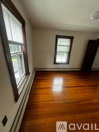 A room with wooden floors and a window.