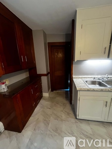 A kitchen with wooden cabinets and a white countertop.