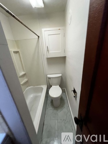 A small bathroom with a toilet and a bathtub.