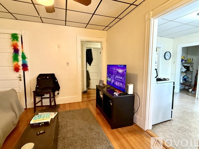 A living room with a television and a chair.