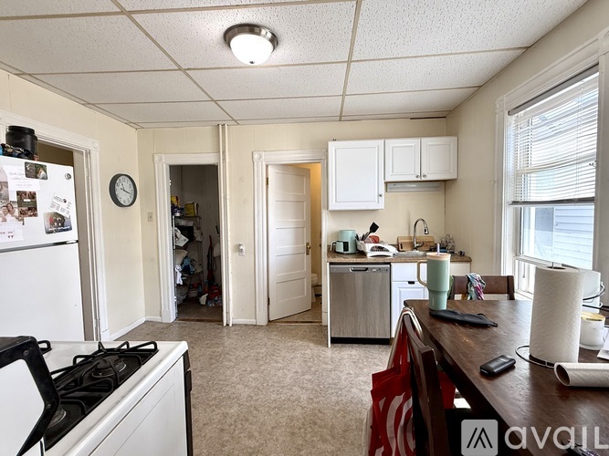 A kitchen with white appliances and a white fridge.