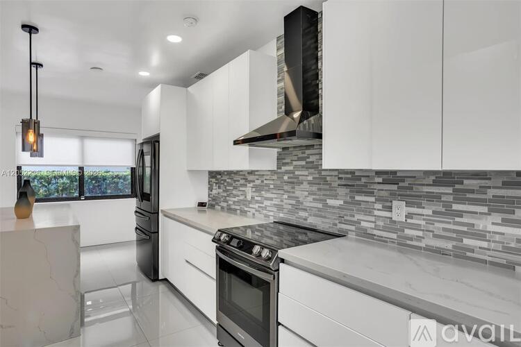 A modern kitchen with a black stove top oven.