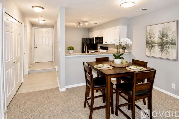 A dining room with a table set for four.