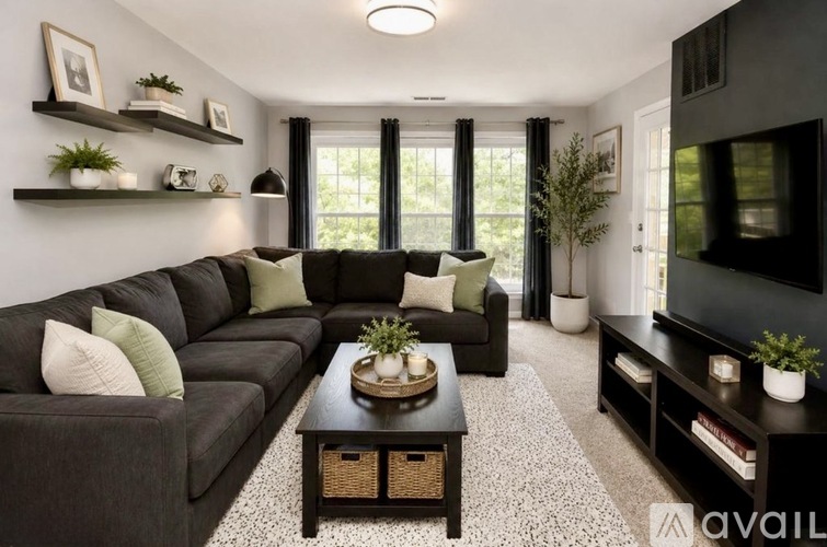 A living room with a grey couch and a coffee table.