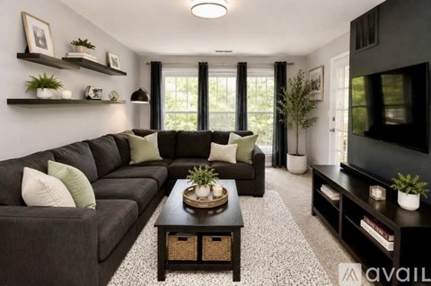 A living room with a grey couch and a coffee table.