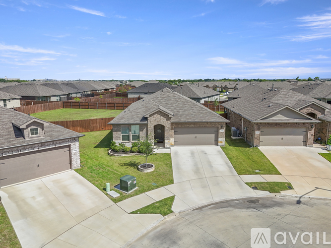 A suburban neighborhood with houses and a clear sky.