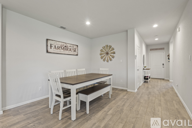 A dining room with a wooden table and chairs.