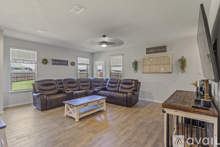 A living room with a large sectional sofa and a coffee table.
